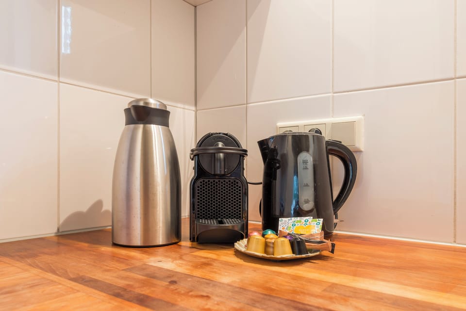A close-up of the kitchen's thoughtful setup, showcasing essential appliances for everyday convenience and culinary creativity.