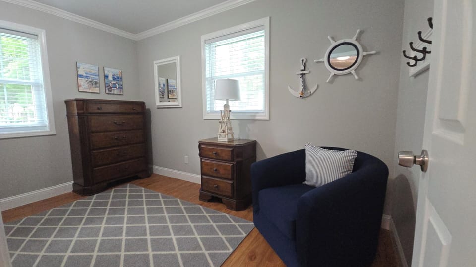 Bunkbed room with a comfortable chair to sit.