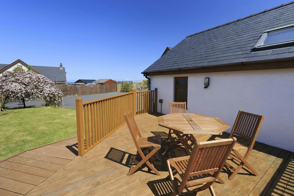 Deck outside with picnic table and four chairs
