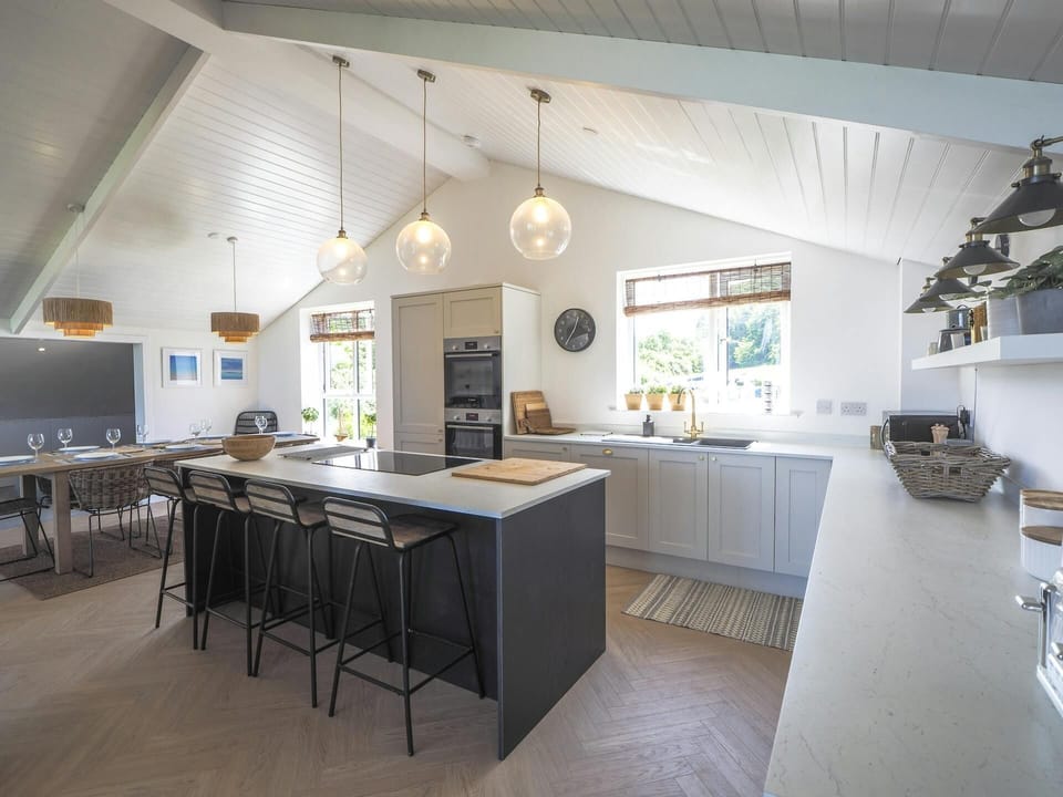 Kitchen with island unit and stools