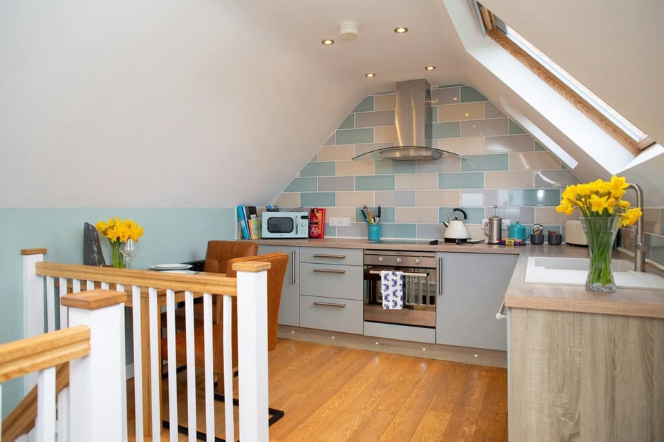 Kitchen area with electric oven, hob and extractor hood