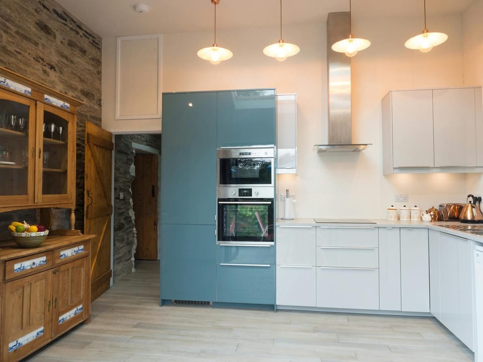 Kitchen with built in oven, hob, extractor fan, kettle, toaster and Welsh Dresser