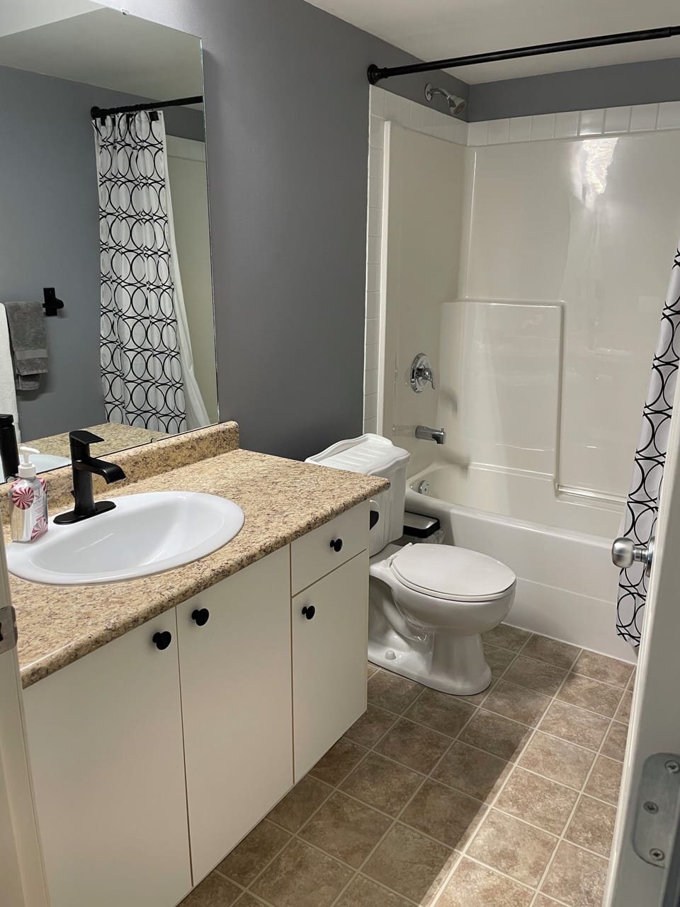 Three piece bathroom with tub, shower and closet space