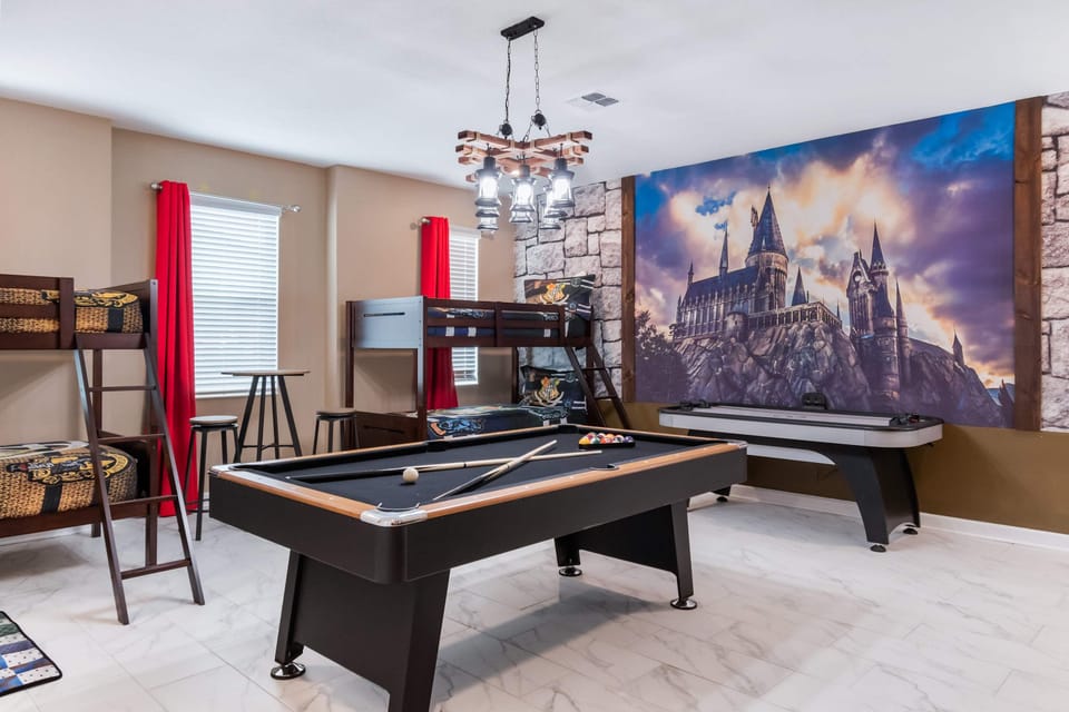 Wizard-themed game room with bunk beds, pool, air hockey, and Hogwarts mural
