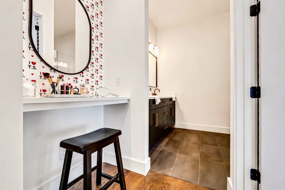 Full vanity with makeup mirror and themed wallpaper in the bathroom, a proper getting-ready station for bachelorette parties and friend getaways