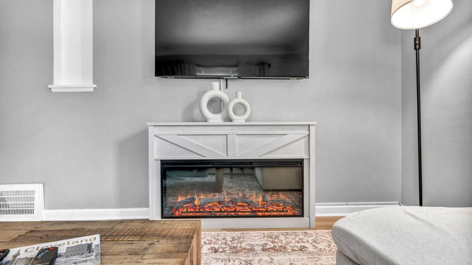 Living room with an electric fireplace for the vibes—soft glow, cozy warmth, and a relaxing atmosphere. It’s the perfect setting to unwind, enjoy the ambiance, and let the flicker of the flames set the mood.








