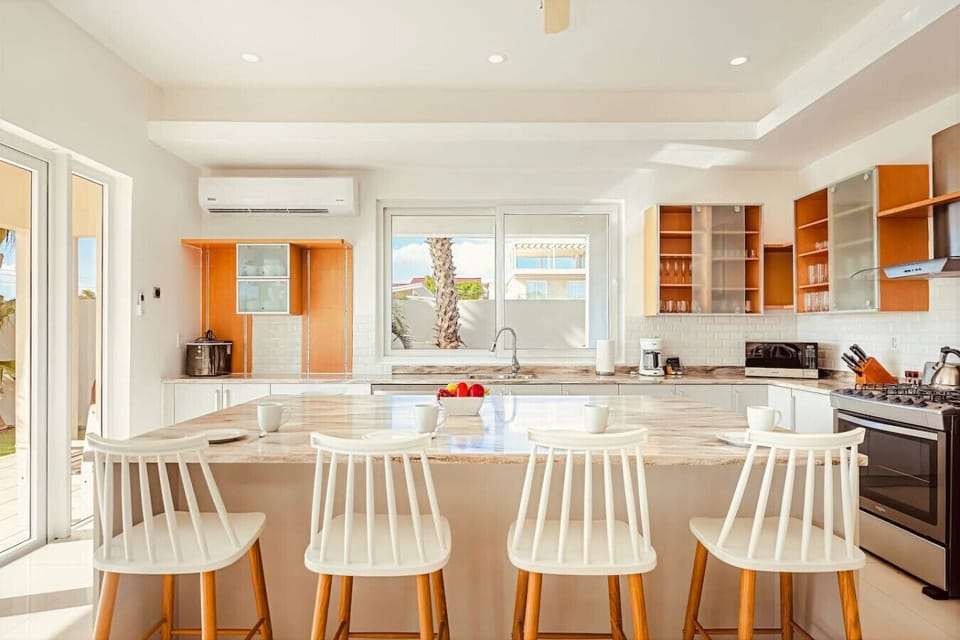 Bright, open kitchen with plenty of space to gather—perfect for slow mornings, shared meals, and easy island living.