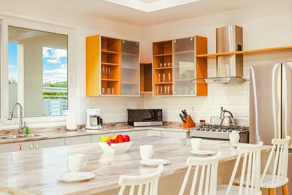 A clean, modern kitchen with everything you need—perfect for easy meals and gathering around the island.