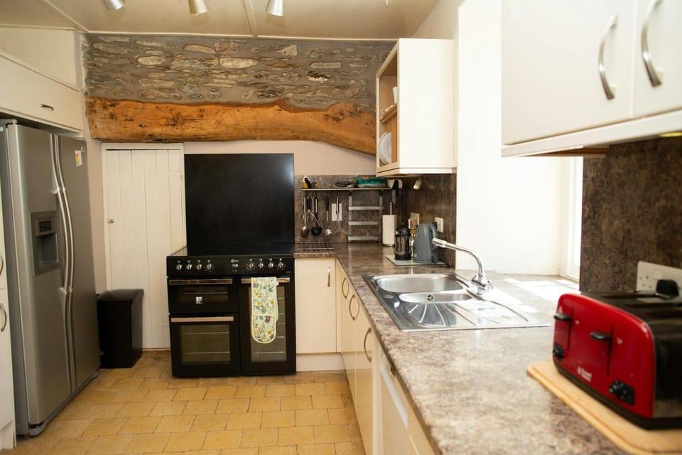 Kitchen with range cooker and American style fridge/freezer, toaster and kettle