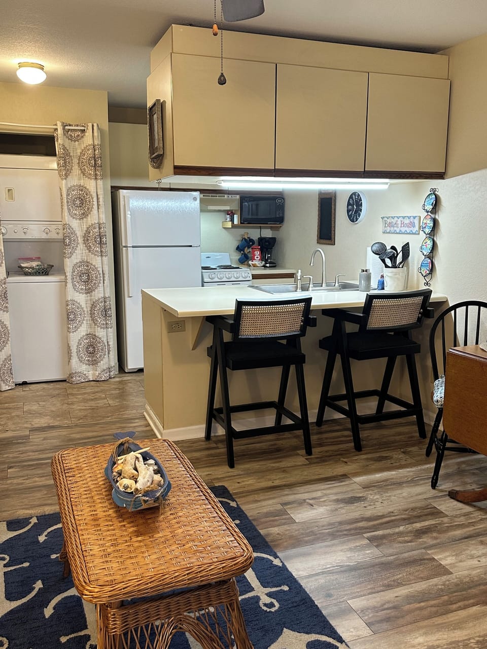 Galley kitchen with stove, refrigerator, microwave, coffee machine, toaster etc