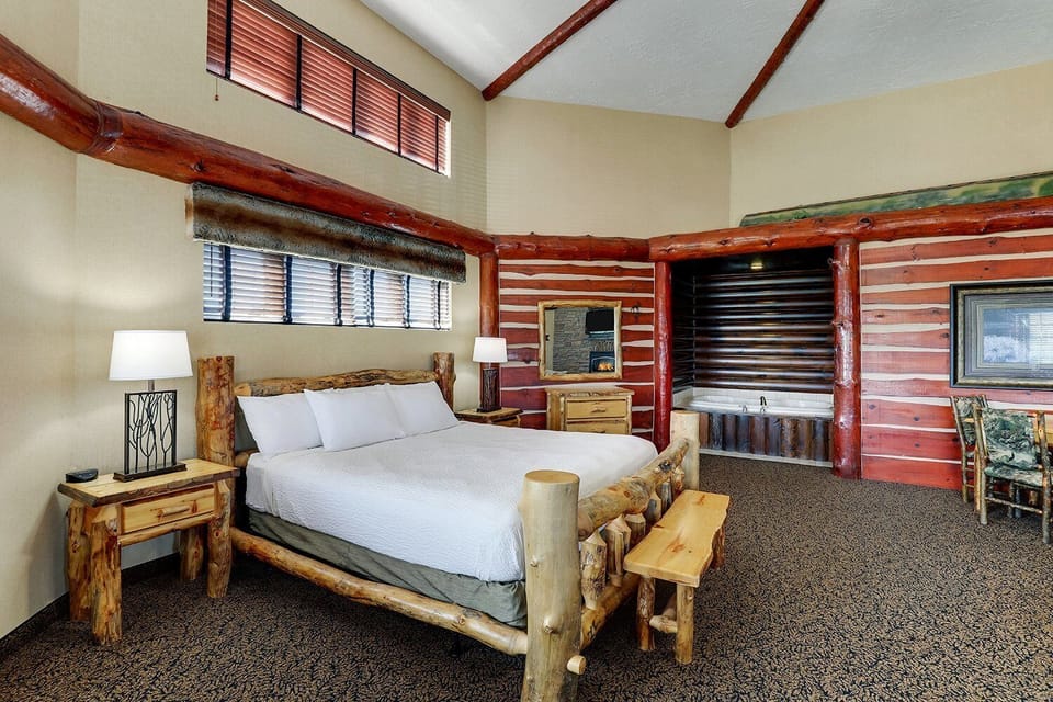 Drift off in a cozy log bed with cabin charm.