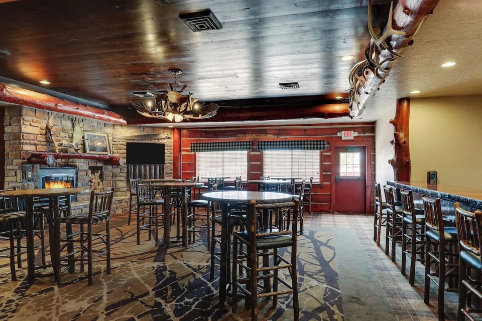 Unwind by the glowing fireplace in a rustic lodge lounge.