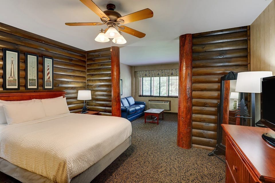 Unwind in a cozy log-style room with plush king bed.