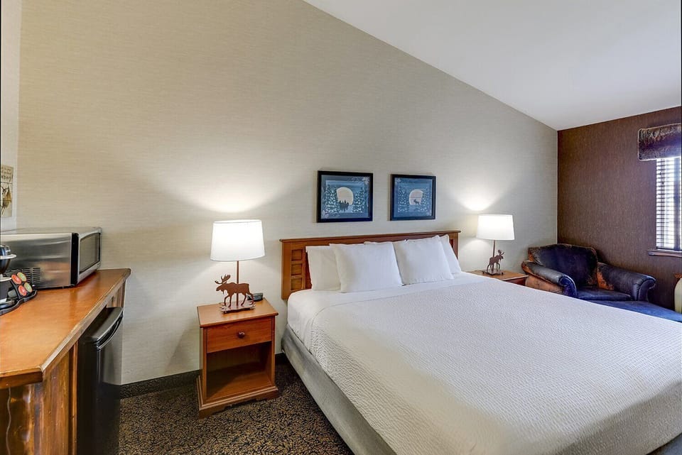 Settle in with bedside lamps and a calm, airy layout.