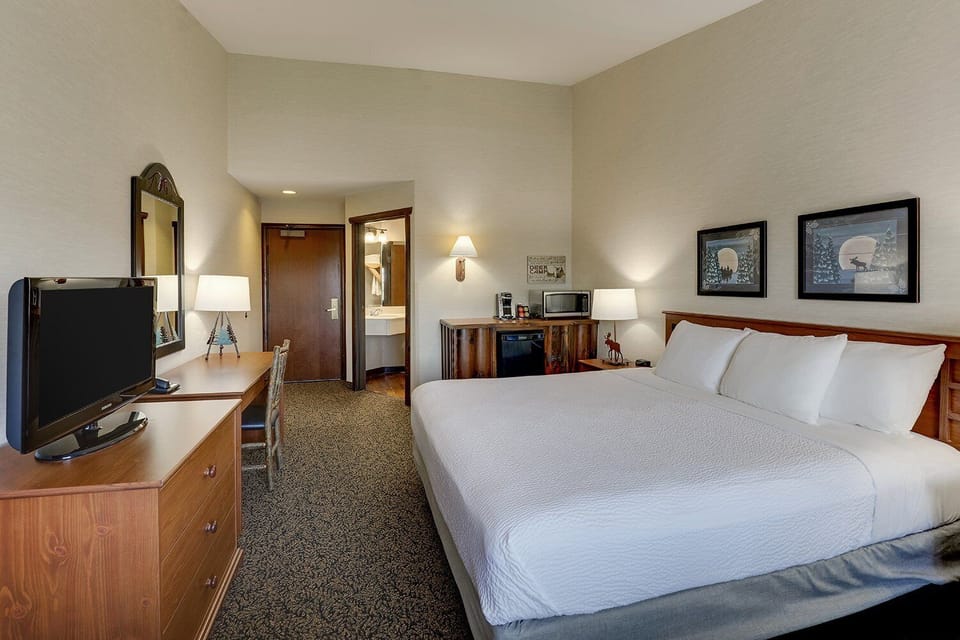 Spread out comfortably with workspace, TV, and crisp king bed.