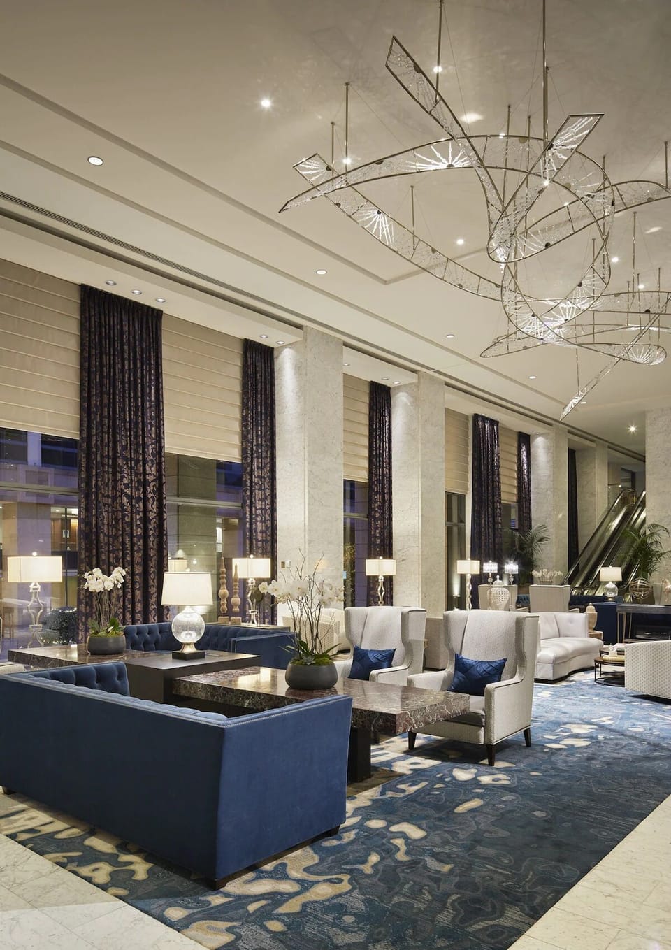 Unwind on plush seating with towering windows and calm ambiance.