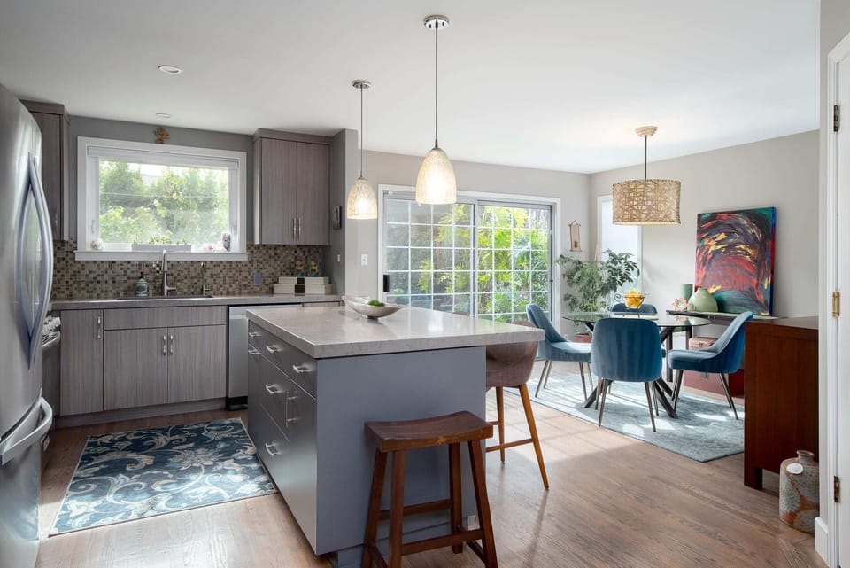 Speaking of the kitchen, here's a closer shot.  It has an island, bright surfaces, modern appliances, and all the kitchenware you would ever need!  In the background you'll see the dining area.