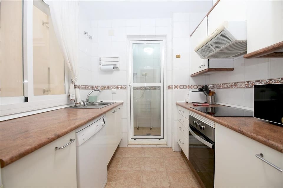 Fully equipped kitchen with laundry room to the rear