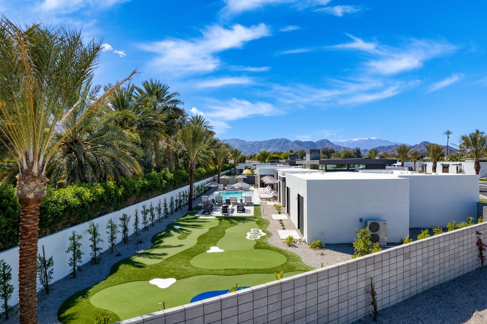 Welcome to your villa retreat- with a green lawn, a pool, and a view of the majestic mountains!