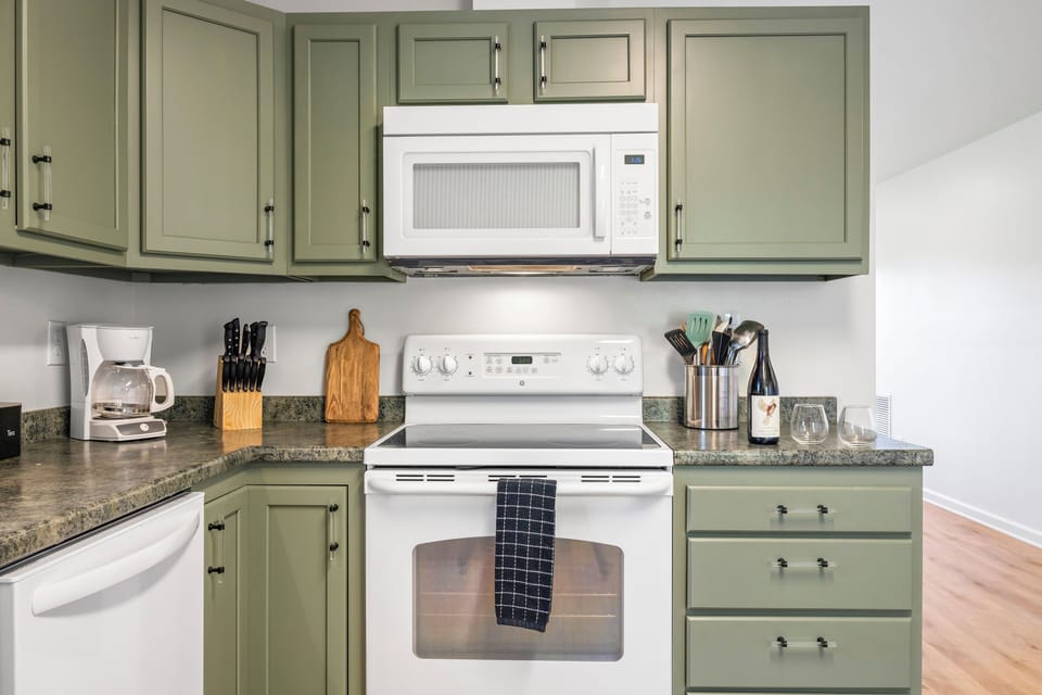 Kitchen with modern stove, microwave, and oven.