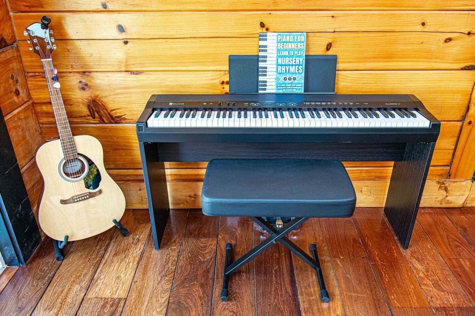 A musician’s nook with piano and guitar, ready for creative inspiration.