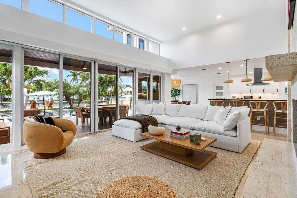 Spacious living area with floor-to-ceiling glass, offering a blend of comfort and elegance with stunning water views.