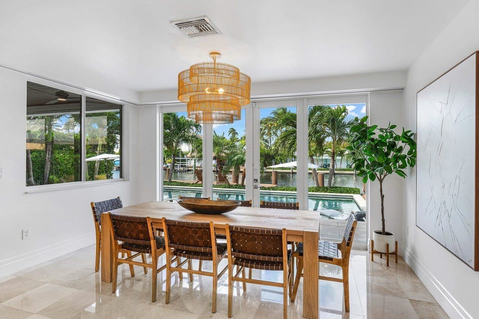 Open, sunlit dining space surrounded by greenery, ideal for enjoying meals with a beautiful backdrop.