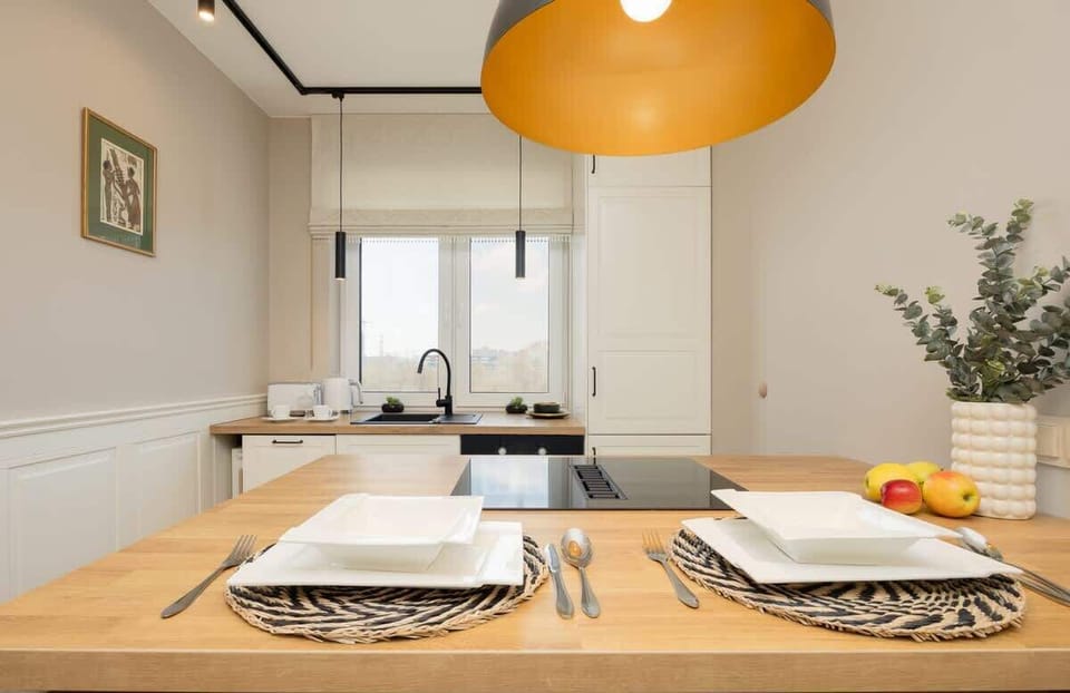 Dining room with a neatly set table under warm lighting.