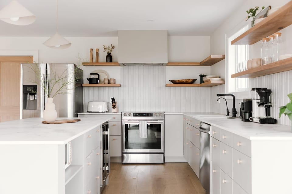 The kitchen is filled with high end cookware and ceramics