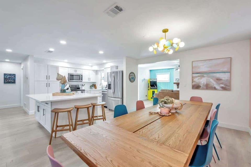 Dining room table for 8 guests and 3 additional stools in the kitchen island
