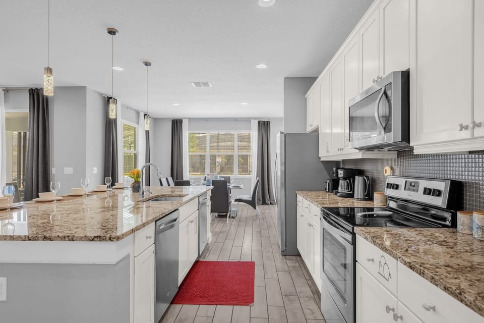 Open-Concept Kitchen With Granite Countertops And Stainless Steel Appliances