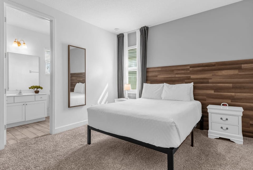 Queen Bedroom With Elegant Wood Accent Wall And Private Bathroom Access