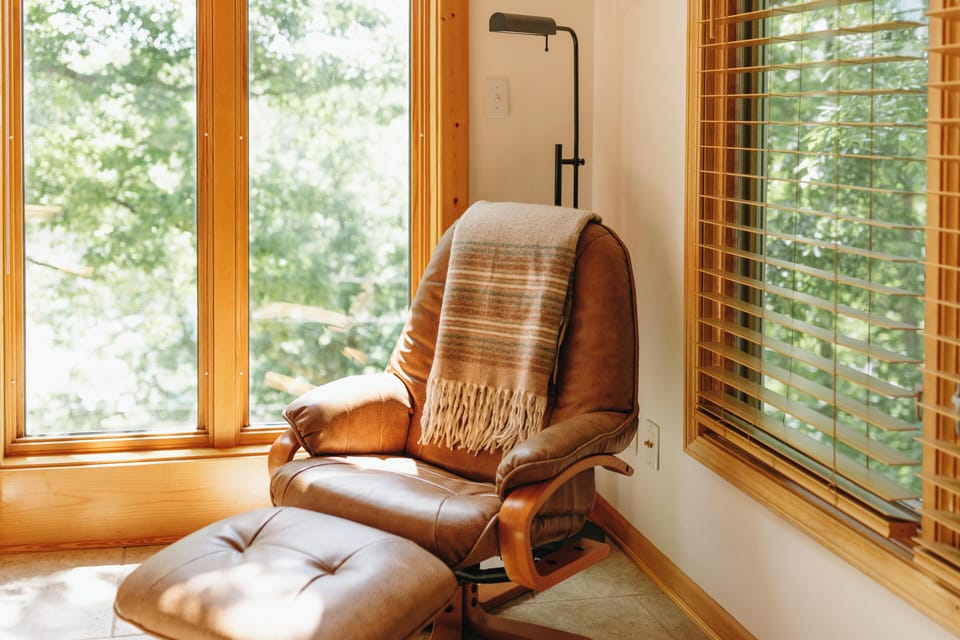Cozy leather reclining chair enjoyed by the fire place.