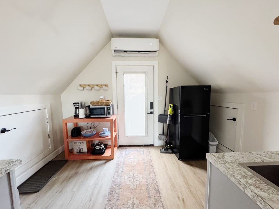 Fully stocked kitchen with countertop cooktop, crock pot, full size fridge, etc.
