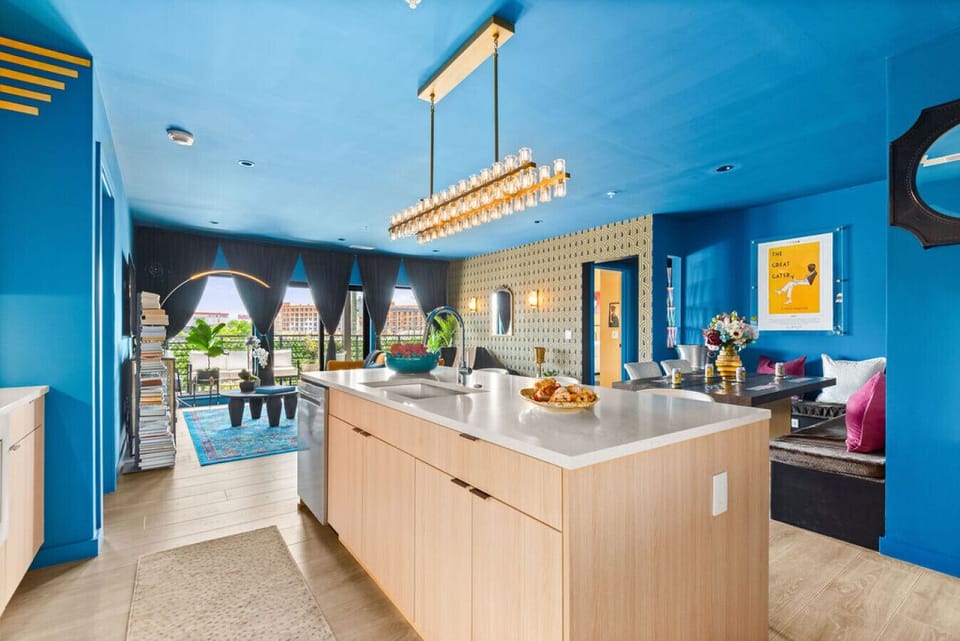 Beautiful light fixture above kitchen island. blending with the `French Riviera` Style of the condo