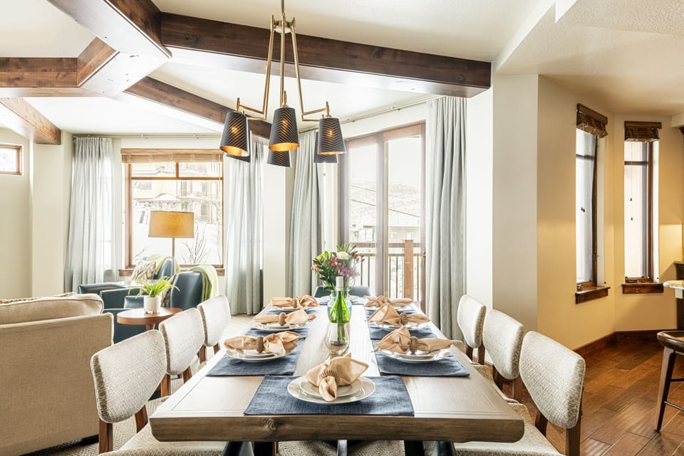 Dining area with a wood table with cushioned chairs offering seating for eight