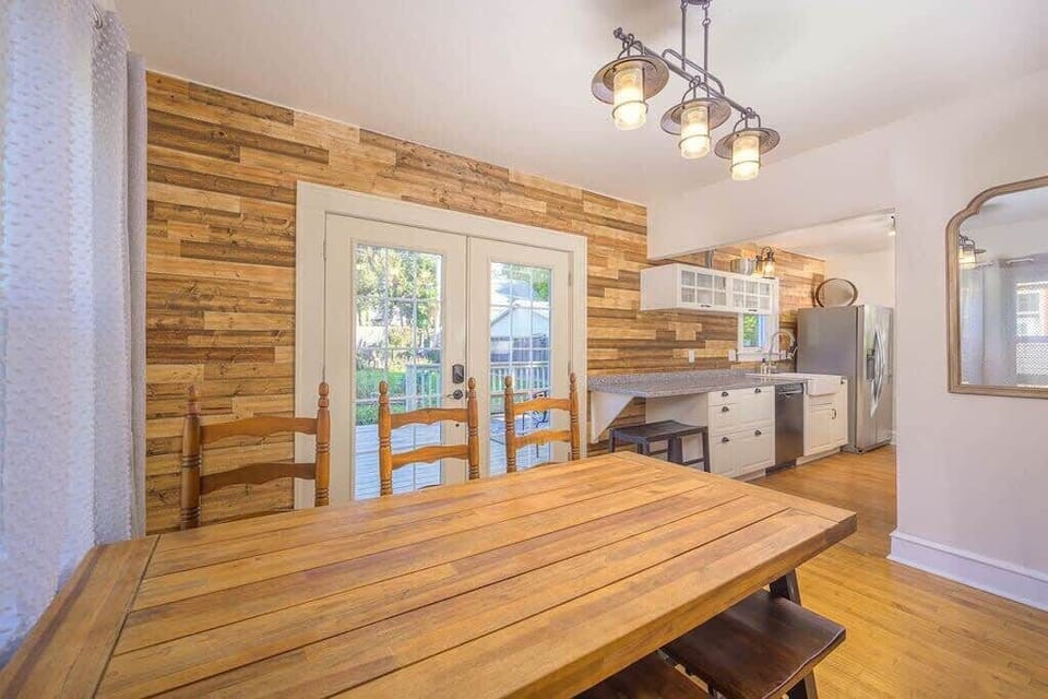 Dining room with double doors leading to the back deck.