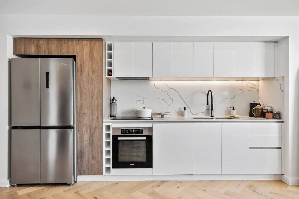 The neat kitchen comes well-equipped for meal preparation at home.
