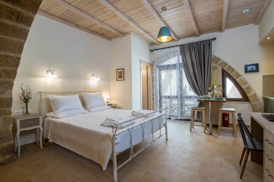 Light-Filled Bedroom with Kitchenette Area, Ensuite Bath, and Outdoor Access