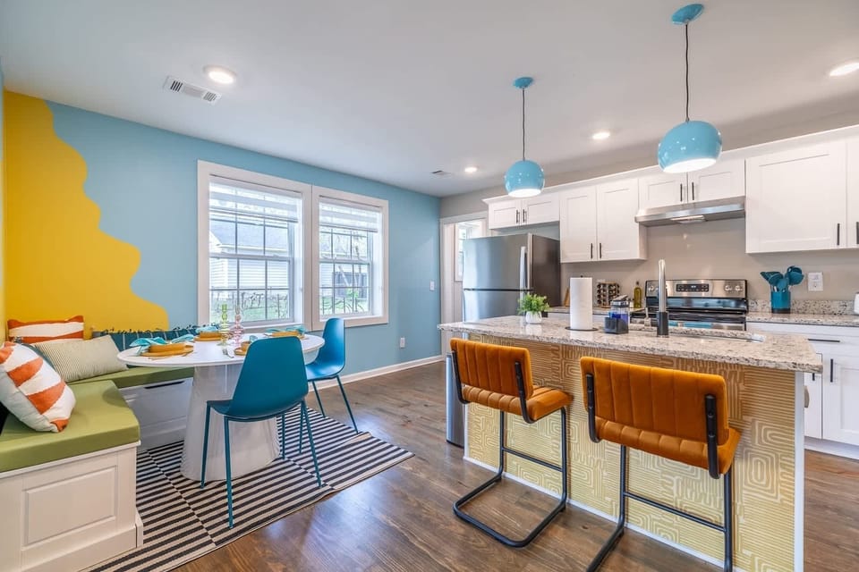 Step into our elegantly appointed dining area, seamlessly connected to a fully equipped kitchen featuring a spacious kitchen island. This thoughtfully designed space not only invites culinary exploration but also serves as the heart of the home, where meals and memories are made in comfort and style.