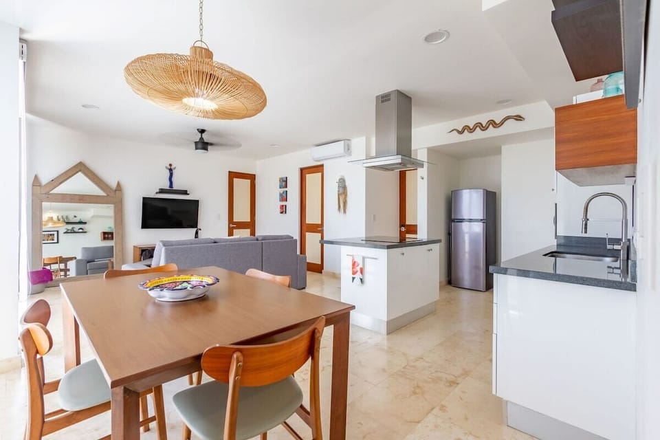 A dining table to seat 4 people comfortably in front of the glass doors