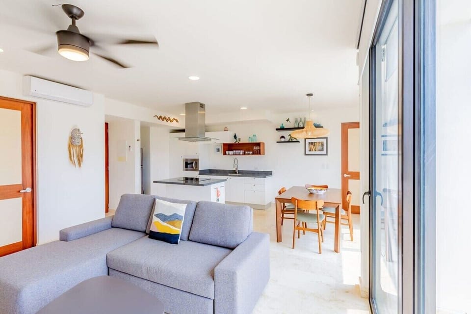 A comfy L-shaped sofa in a luminous living space