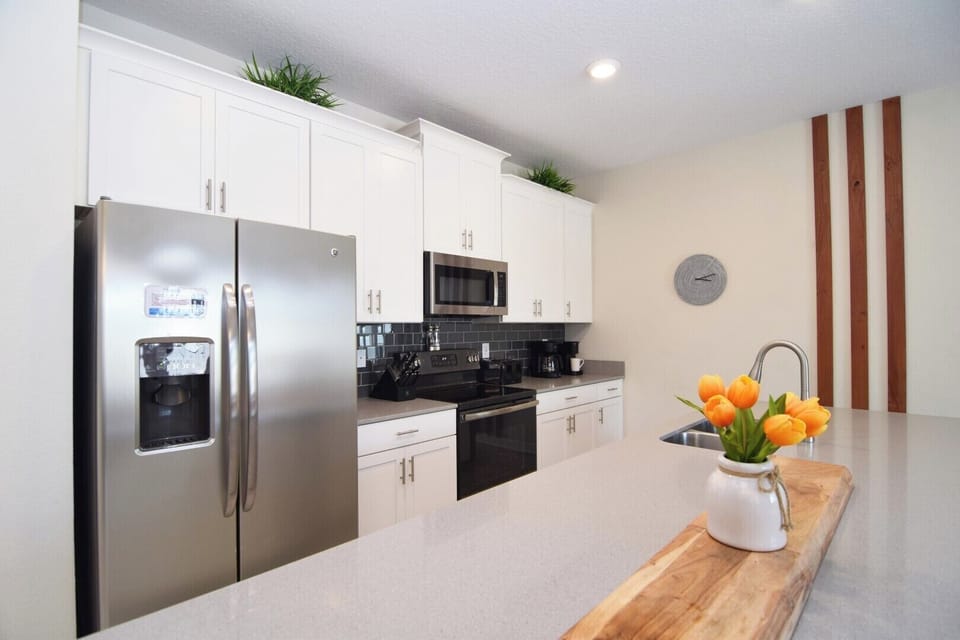 Stylish kitchen with all appliances, dishes, pots, pans needed to dine at home