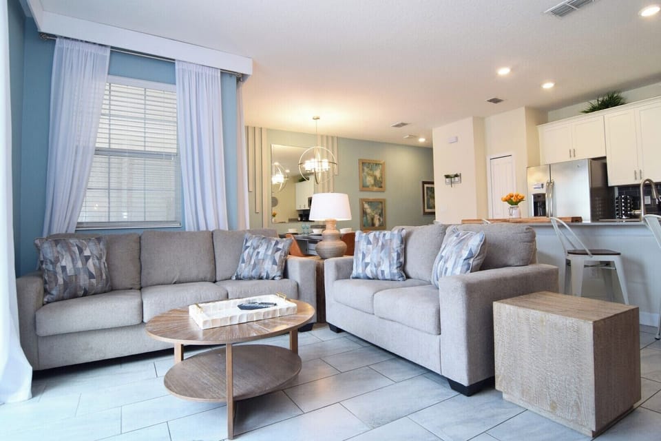 Lounge area with two sofas, Smart TV, sliding doors to the pool deck