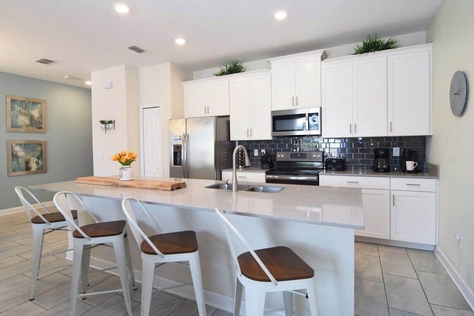 Stylish kitchen with all appliances, dishes, pots, pans needed to dine at home