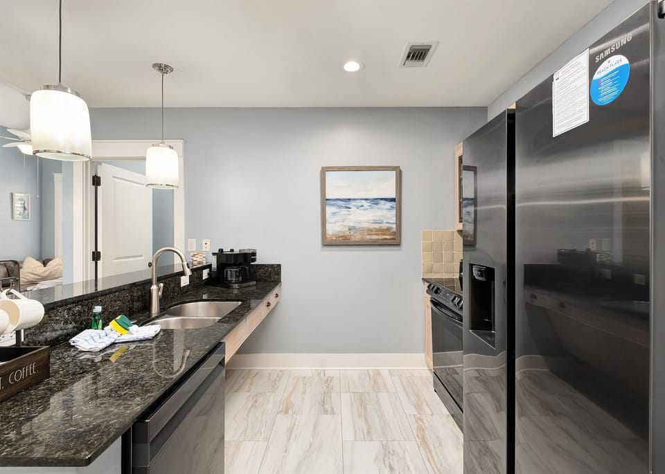 Granite countertops, stainless steel appliances, and stylish pendant lighting make this kitchen as beautiful as it is functional. Everything you need to cook up a delicious meal during your stay.