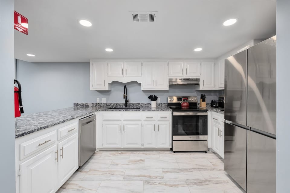 Cook up a feast in the fully equipped kitchen featuring stainless steel appliances and modern amenities.