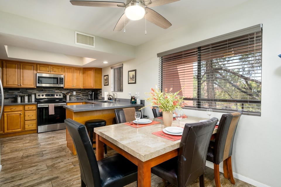 Large dining table with seats for five.