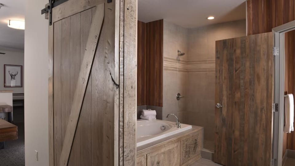 Soak and reset in a deep tub beside walk-in shower.