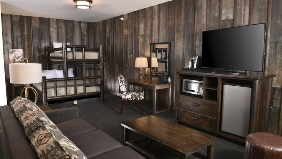 Gather after adventures in a cozy bunk suite with sofa.